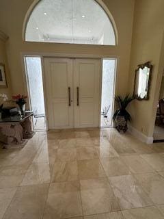 3271 Harrington Dr, Boca Raton, FL 33496 - foyer with a towering ceiling and baseboards