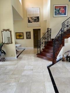 3271 Harrington Dr, Boca Raton, FL 33496 - foyer featuring a towering ceiling, stairway, and baseboards