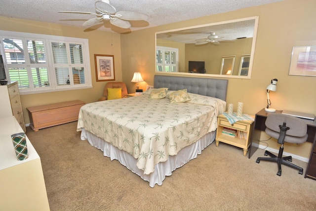 carpeted bedroom with a ceiling fan, a textured ceiling, and baseboards