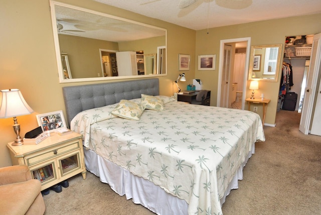 bedroom with light carpet, connected bathroom, a ceiling fan, a spacious closet, and a closet