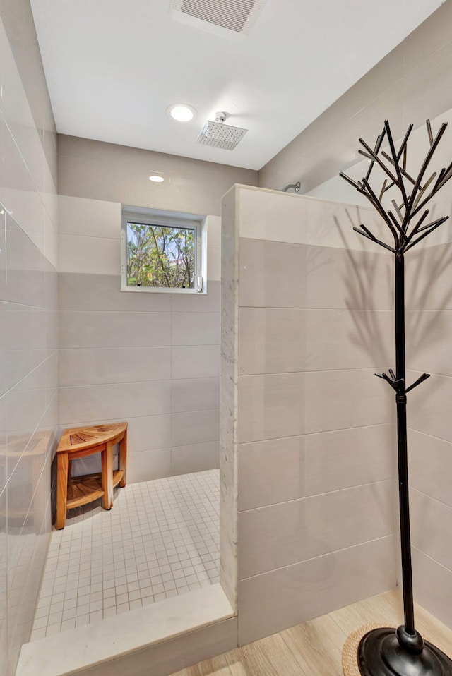 bathroom with visible vents and walk in shower