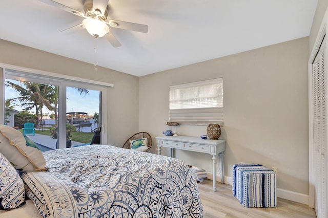 bedroom with a ceiling fan, baseboards, access to outside, a closet, and light wood-type flooring