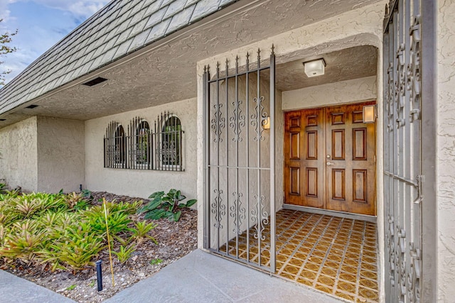 doorway to property with stucco siding