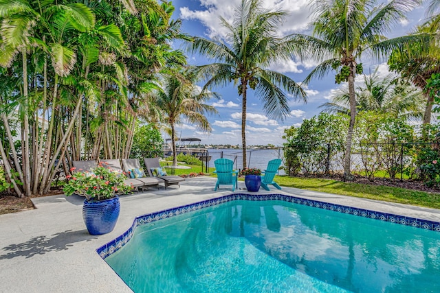 view of swimming pool with a patio area, fence, and a fenced in pool