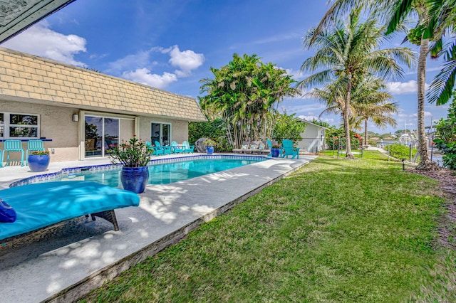 pool featuring a yard and a patio