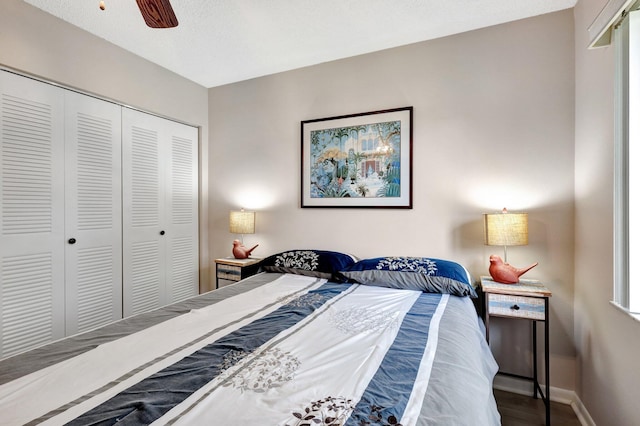 bedroom with a ceiling fan, baseboards, a closet, and wood finished floors