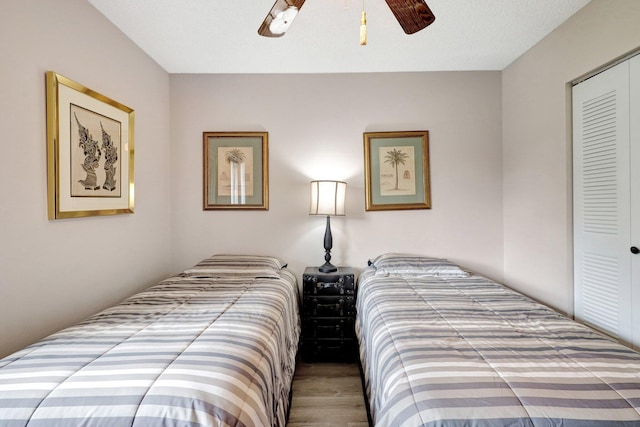 bedroom featuring a closet, wood finished floors, and a ceiling fan