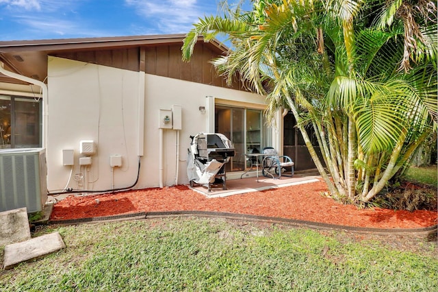 back of property featuring central AC and a patio