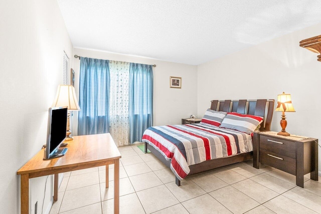 bedroom featuring a textured ceiling and light tile patterned floors