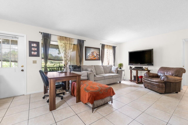 living area featuring light tile patterned flooring and a textured ceiling