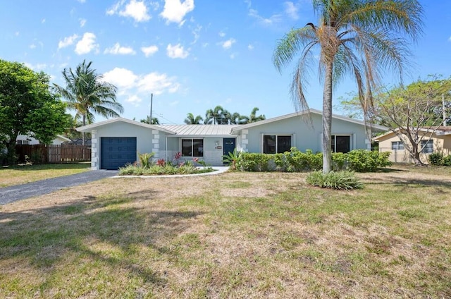 514 Jaeger Dr, Delray Beach, FL 33444 - ranch-style home with an attached garage, asphalt driveway, metal roof, and stucco siding