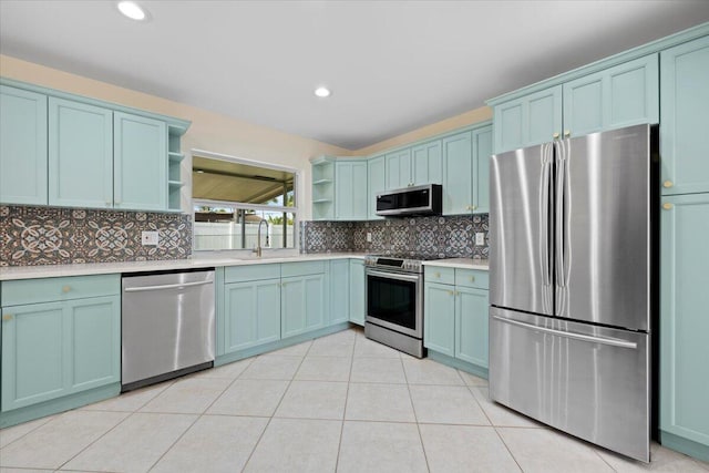 514 Jaeger Dr, Delray Beach, FL 33444 - kitchen featuring stainless steel appliances, open shelves, a sink, light countertops, and tasteful backsplash