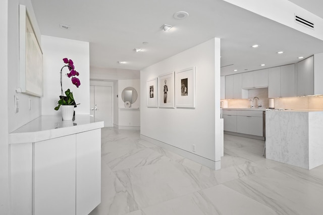 corridor featuring baseboards, marble finish floor, visible vents, and recessed lighting