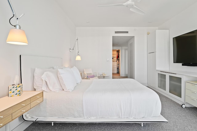 carpeted bedroom with visible vents and a ceiling fan