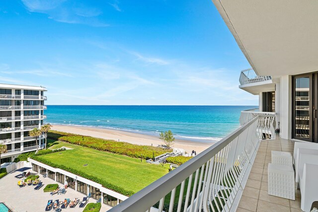 balcony with a water view and a beach view