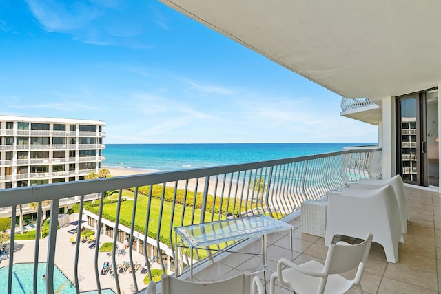 balcony featuring a water view and a beach view