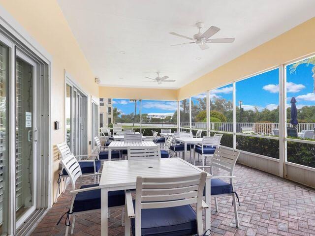 sunroom featuring ceiling fan and outdoor dining area