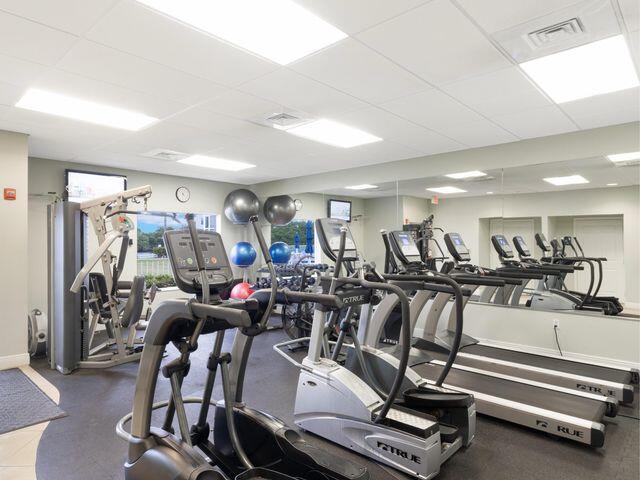 workout area with a paneled ceiling and visible vents