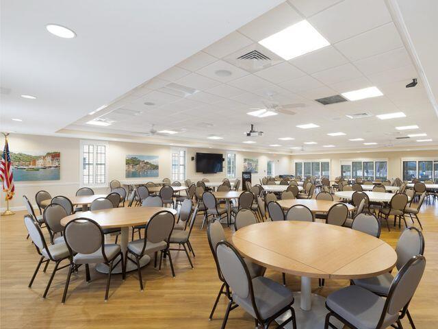 dining area with a drop ceiling, ceiling fan, a wealth of natural light, light wood-style flooring, and visible vents