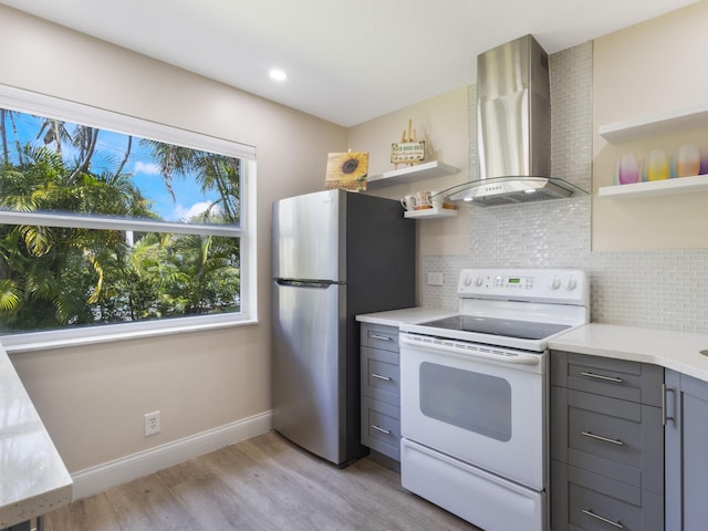 kitchen featuring open shelves, white electric stove, wall chimney range hood, and gray cabinetry