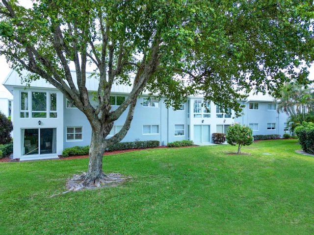 exterior space with a lawn and stucco siding