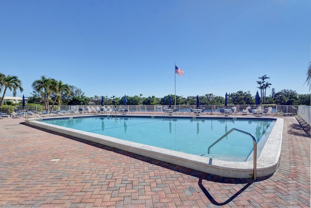 pool featuring fence and a patio