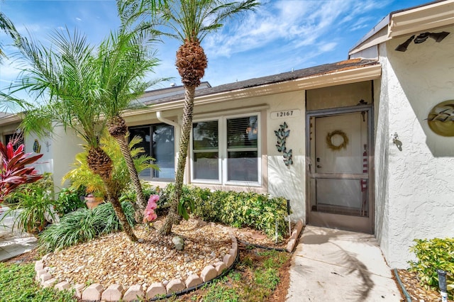 entrance to property with stucco siding