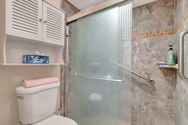 bathroom featuring a shower stall and toilet