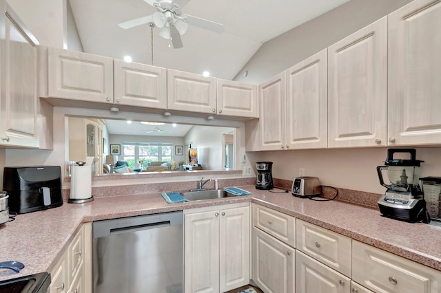 kitchen with a sink, white cabinets, light countertops, and stainless steel dishwasher