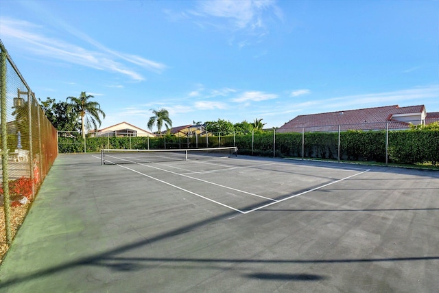 view of tennis court featuring fence