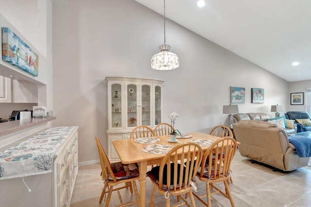 dining area featuring recessed lighting, baseboards, high vaulted ceiling, and light tile patterned flooring