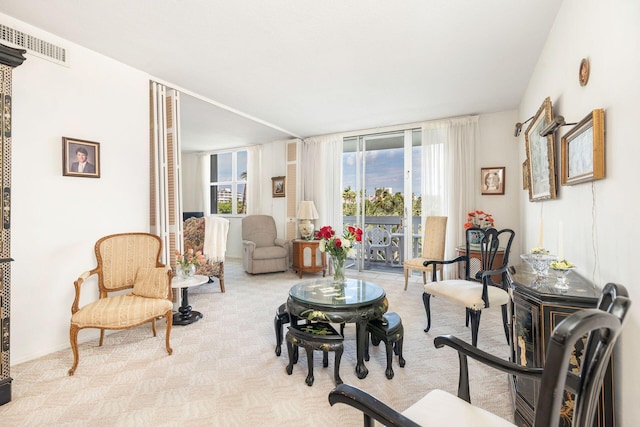 sitting room featuring light carpet and visible vents