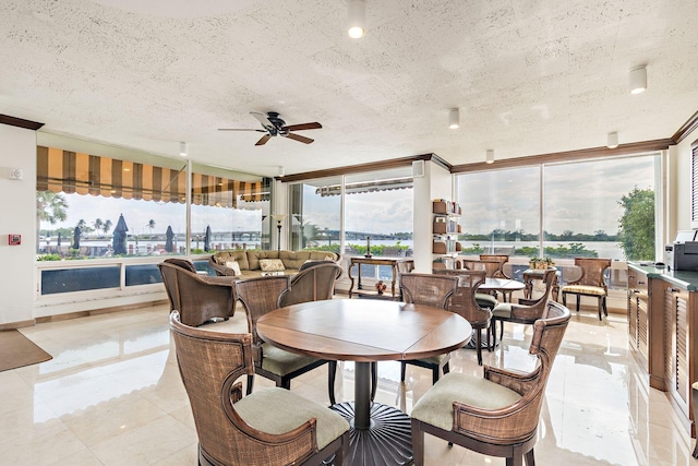 dining space featuring a textured ceiling and a ceiling fan