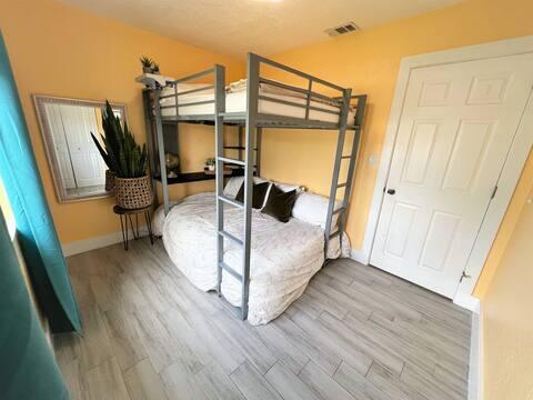 bedroom with visible vents, baseboards, and wood finished floors