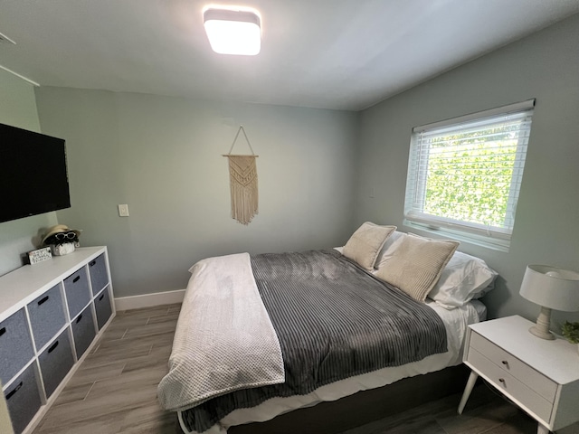 bedroom with light wood-style flooring and baseboards