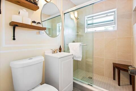 bathroom with toilet, a stall shower, and vanity