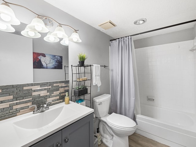 bathroom featuring shower / tub combo with curtain, visible vents, toilet, vanity, and wood finished floors