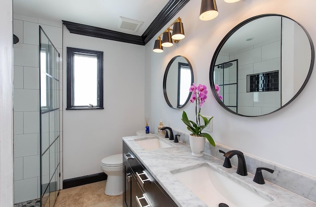 bathroom featuring toilet, double vanity, ornamental molding, and a sink