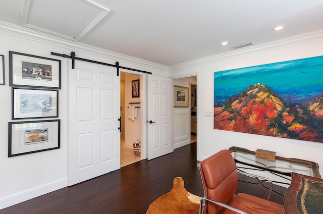 sitting room with dark wood-style flooring, crown molding, visible vents, a barn door, and baseboards