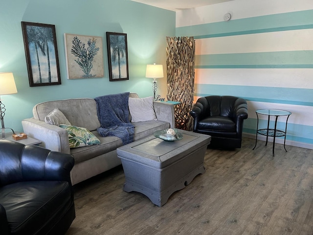 living area with baseboards and wood finished floors