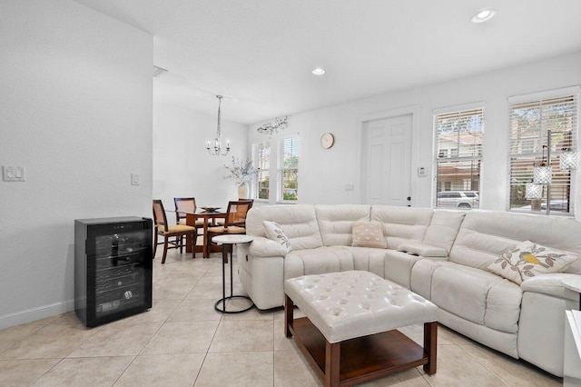 living area with recessed lighting, beverage cooler, a notable chandelier, and light tile patterned floors