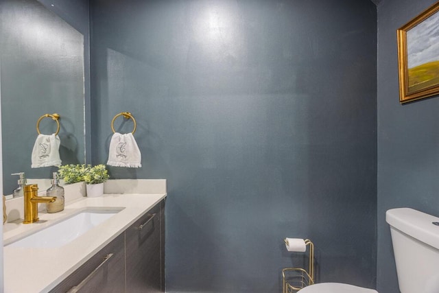 bathroom featuring toilet and vanity