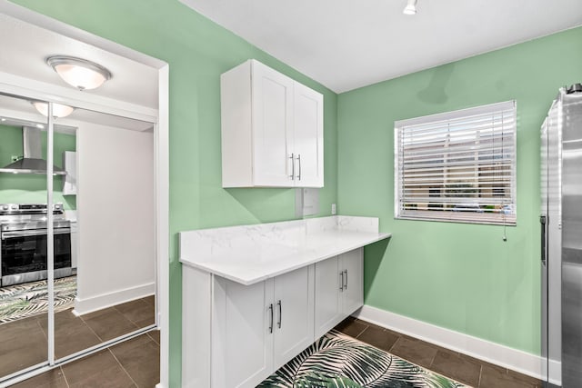 laundry room with baseboards