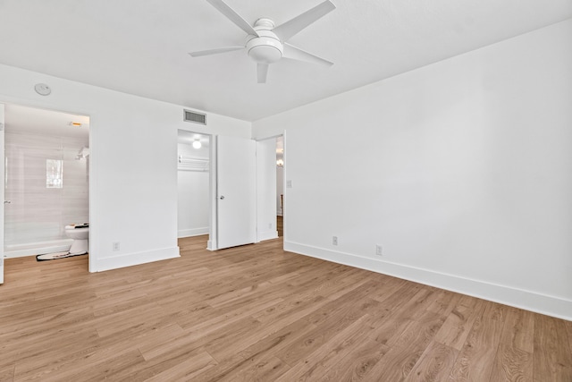 unfurnished bedroom with light wood-style floors, baseboards, a spacious closet, and visible vents