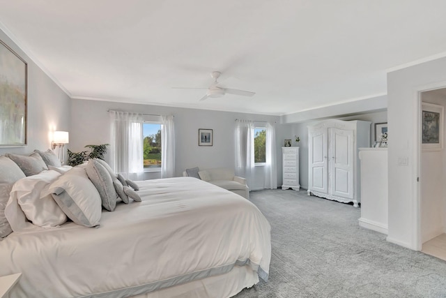 bedroom with light carpet, ceiling fan, and crown molding