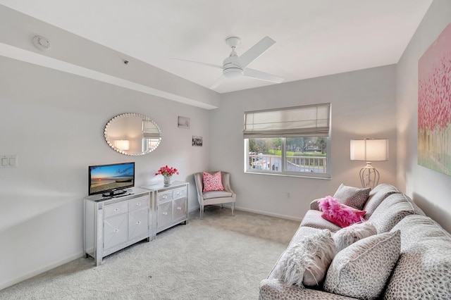 sitting room with light carpet, ceiling fan, and baseboards