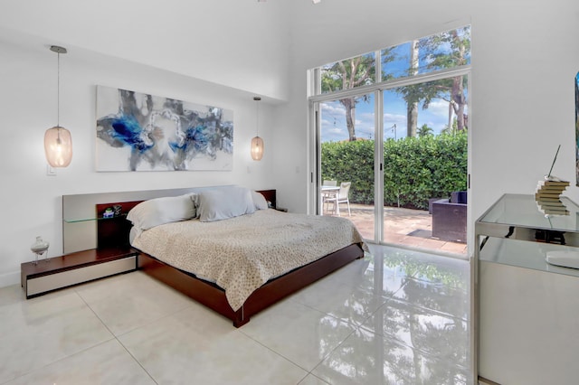 bedroom featuring a high ceiling, tile patterned floors, and access to exterior