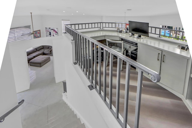 stairs with tile patterned flooring and recessed lighting