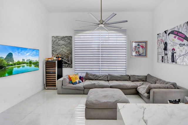 living area with beverage cooler, light tile patterned floors, and baseboards