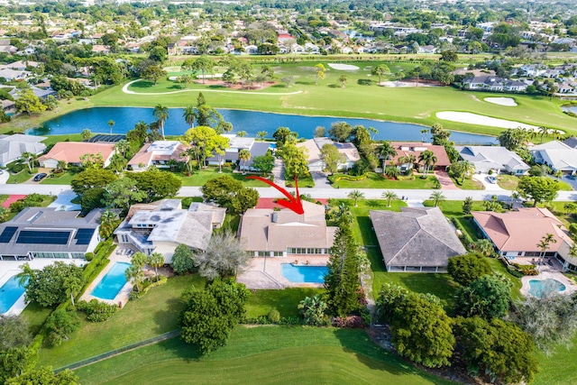 birds eye view of property with a residential view, golf course view, and a water view